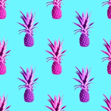 Seamless pattern of pink pineapples isolated on blue background Stock Photos