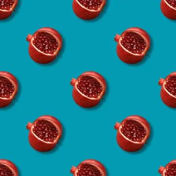 Seamless pattern with pomegranates on a blue background. Stock Photos