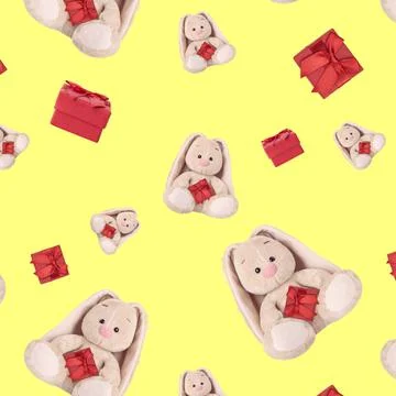 Seamless pattern with a rabbit and a red gift. Stockfoto's