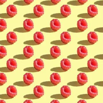 Seamless pattern of raspberry berries on a yellow background. 스톡 사진
