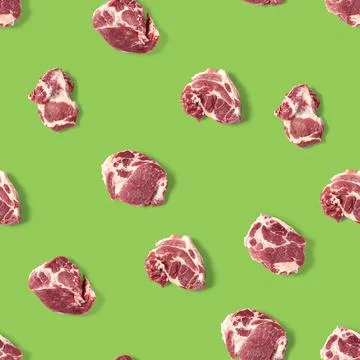 Seamless Pattern with raw pork meat slices on green background, food pattern Stock Photos