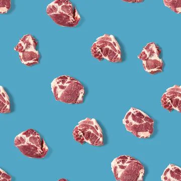 Seamless Pattern with raw pork meat slices on blue background, food pattern Stock Photos