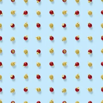 Seamless pattern with red and gold Christmas decorations on blue background.  Stock Photos