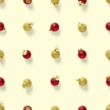 Seamless pattern with red and gold Christmas decorations on yellow background Stock Photos