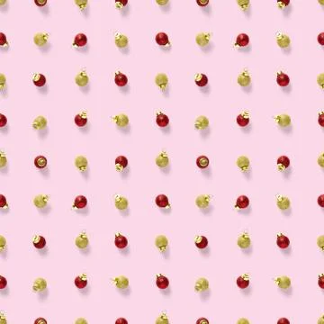 Seamless pattern with red and gold Christmas decorations on pink background.  Stock Photos