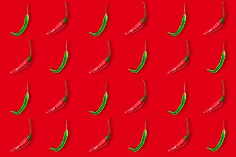 Seamless pattern of red and green hot chili peppers isolated on red background Stock Photos