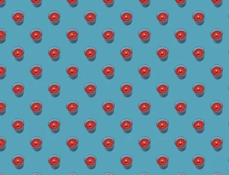 Seamless pattern of red candles on a blue background. Stock Illustration