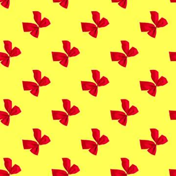 Seamless pattern with red Christmas bows on a yellow background. Minimal isom Fotos de archivo