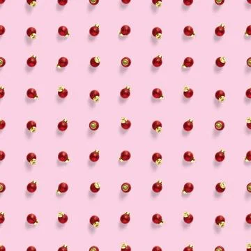 Seamless pattern with red Christmas decorations on pink background. Christmas Stock Photos