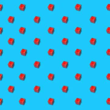 Seamless pattern of red gift box with ribbon on a blue surface Foto stock