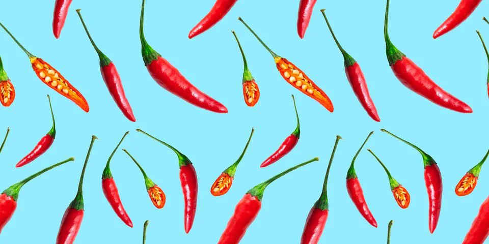 Seamless pattern of red hot chilli peppers isolated on blue background. Top view Stock Photos