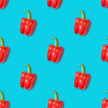 Seamless pattern with red pepper on blue background. Vegetable pattern. Stock Photos