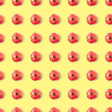 Seamless pattern with red pomegranate fruit on yellow background. Minimal flat Stock Photos
