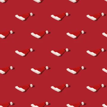 Seamless pattern with Red Santa Claus hat on monohomic background. Minimalistic Stock Photos