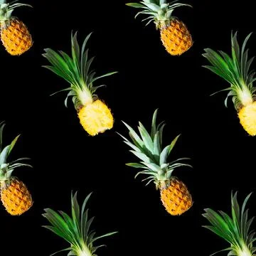 Seamless pattern of ripe pineapples isolated on black background. Exotic fruit Stock Photos