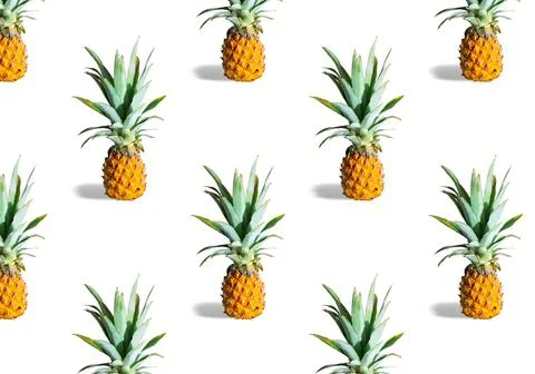 Seamless pattern of ripe pineapples isolated on white background. Exotic fruit Stock Photos