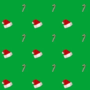 Seamless pattern Santa hat and candy cane candy cane on green background 写真素材