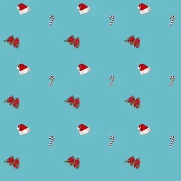 Seamless pattern Santa hat, bow and candy cane candy cane on blue background 写真素材