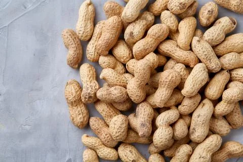 Seamless pattern shelled peanuts isolated on white background, top view, close Stock Photos