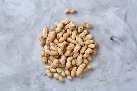 Seamless pattern shelled peanuts isolated on white background, top view, close Stock Photos