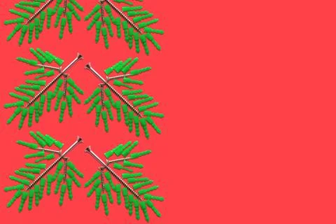 Seamless pattern of spruce twigs folded from plastic dowels and metal screws Stock Photos