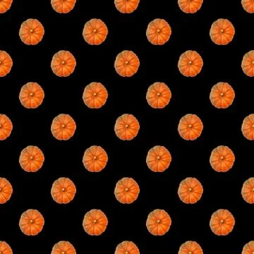 Seamless pattern. Top view of an orange pumpkin on a black background. Concep Stock Photos