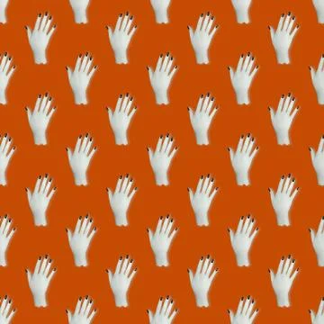 Seamless pattern. Top view of a white hand with black nails on an orange back Stock Photos