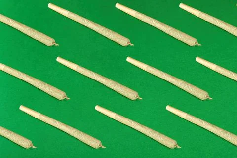 Seamless pattern of twisted joints on a green background Stock Photos