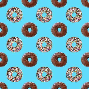 Seamless Pattern of Two Types of Chocolate Glazed Donuts on Sky Blue Backdrop Stock Photos