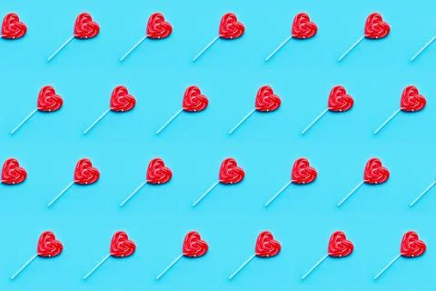 Seamless pattern. Valentines Day bckground. Lollipop candy hearts on blue Stock Photos