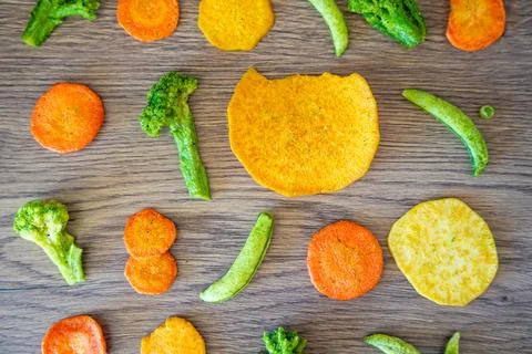 Seamless pattern of vegetable chips with broccoli carrot peas and sweet potato Stock Photos