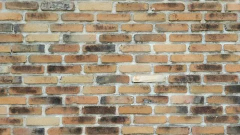 Seamless pattern of weathered, vintage bricks in warm earth tones Stock Photos