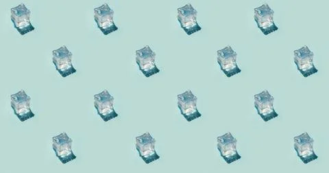 Seamless pattern of wet ice cubes on a plain blue background Stock Photos