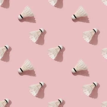 Seamless pattern of white badminton feather shuttlecocks on pink . Stock Photos