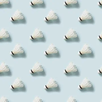 Seamless pattern of white badminton feather shuttlecocks on blue. Stock Photos