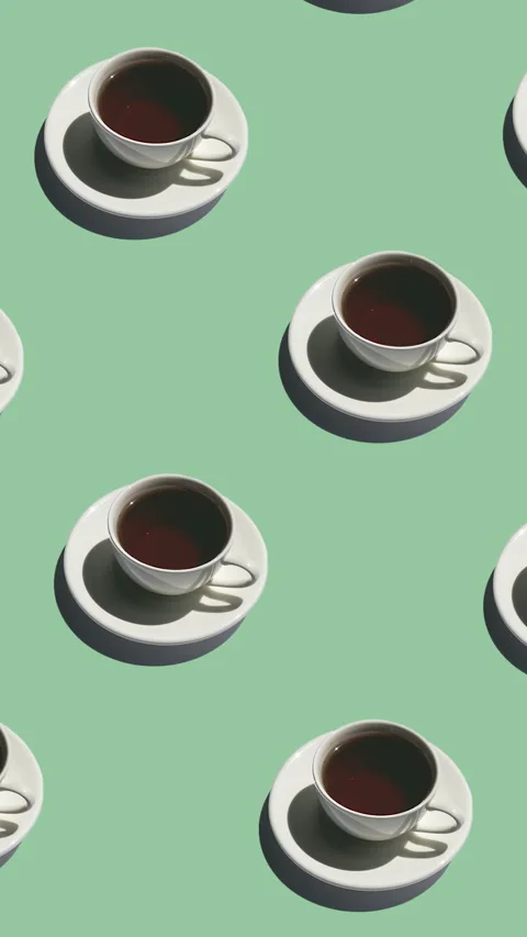 Seamless pattern of white cups with tea with strong shadows on a green Stock Footage 318511024