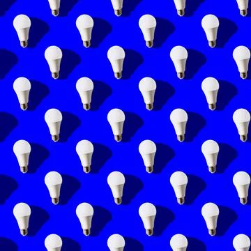 Seamless pattern. white lightbulbs is up on dark blue background. geometric a Stock Photos