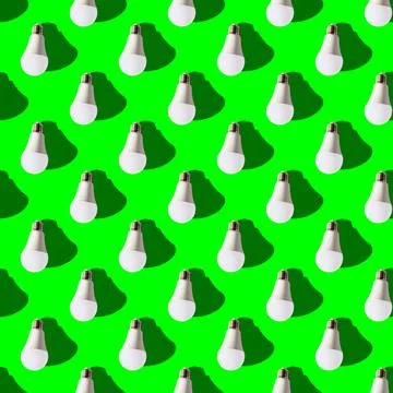Seamless pattern. white lightbulbs is down on green background. geometric arr Stock Photos