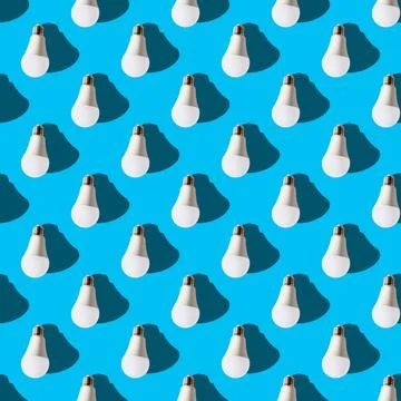 Seamless pattern. white lightbulbs is down on light blue background. geometri Stock Photos
