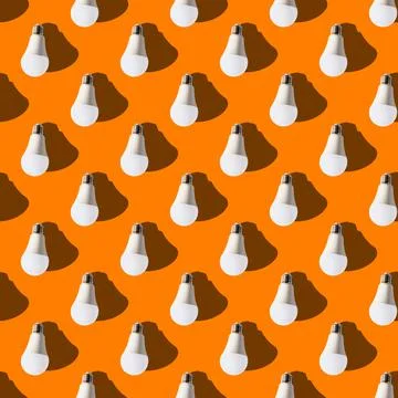 Seamless pattern. white lightbulbs is down on orange background. geometric ar Stock Photos