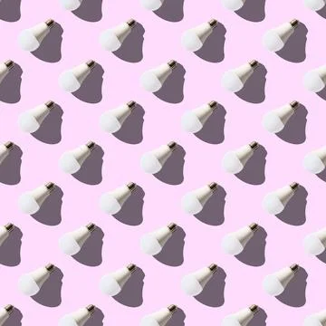Seamless pattern. white lightbulbs is left down on pink background. geometric Stock Illustration