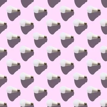 Seamless pattern. white lightbulbs is left on pink background. geometric arra Stock Illustration