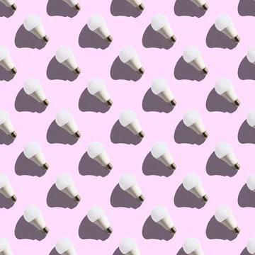 Seamless pattern. white lightbulbs is left up on pink background. geometric a Stock Illustration