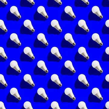 Seamless pattern. white lightbulbs is left up on dark blue background. geomet Stock Photos