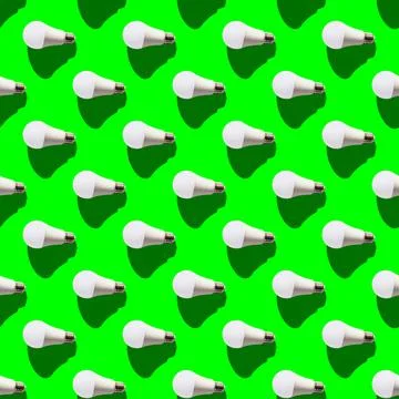 Seamless pattern. white lightbulbs is left on green background. geometric arr Stock Photos