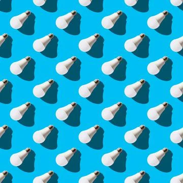 Seamless pattern. white lightbulbs is left down on light blue background. geo Stock Photos