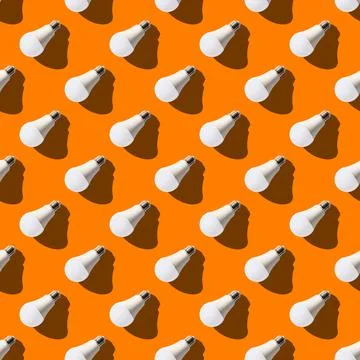 Seamless pattern. white lightbulbs is left down on orange background. geometr Stock Photos