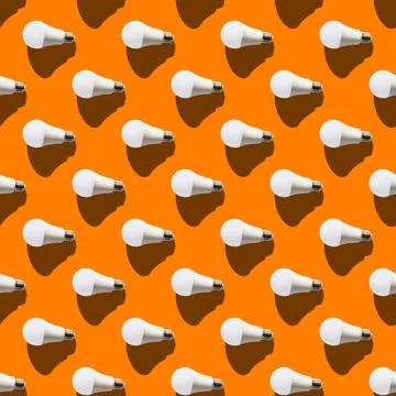 Seamless pattern. white lightbulbs is left on orange background. geometric ar Stock Photos