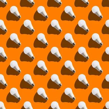 Seamless pattern. white lightbulbs is left up on orange background. geometric Stock Photos