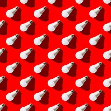 Seamless pattern. white lightbulbs is left down on red background. geometric  Stock Photos